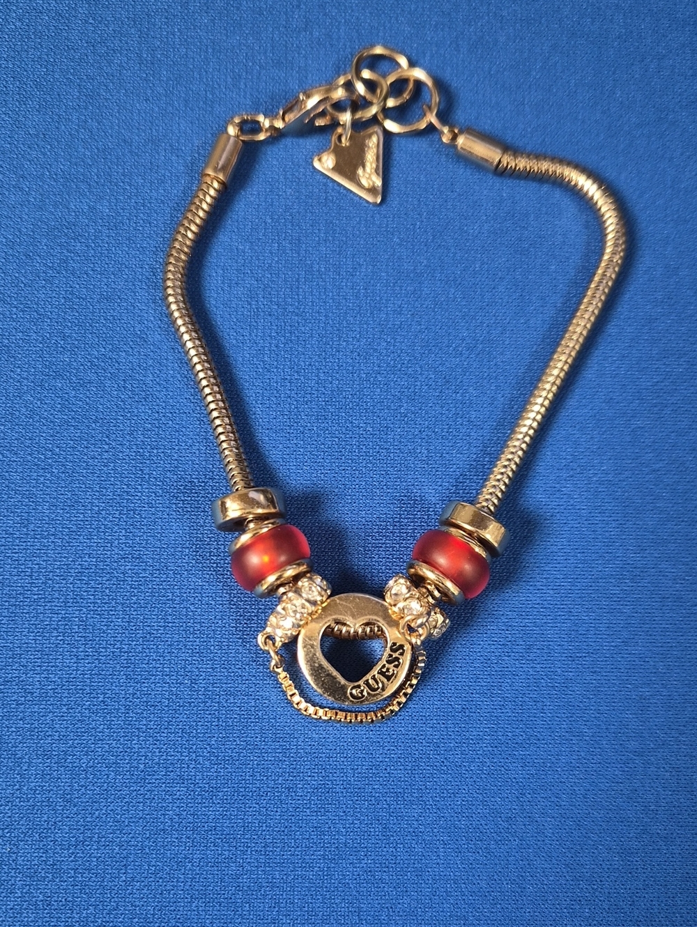 Guess Gold-Tone Bracelet with Red Accent Beads and Heart Charm